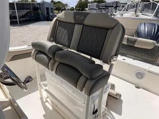 Slide: The Image of 2025 Key West 239 FS boat seating with cushioned backrest and armrests. - 26