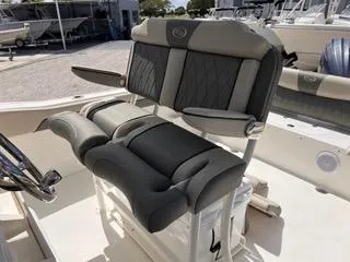 Slide: The Image of 2025 Key West 239 FS boat interior with cushioned seating and steering wheel. - 27