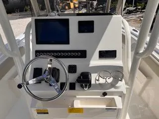Slide: The Image of 2025 Key West 239 FS boat console with steering wheel and electronic controls. - 30