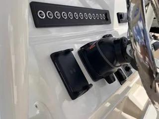 Slide: The Image of Control panel of 2025 Key West 239 FS boat with switches and steering wheel. - 31