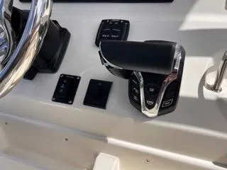 Slide: The Image of Control panel of 2025 Key West 239 FS boat with steering wheel and throttle. - 32