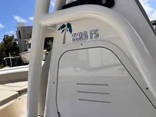 Slide: The Image of 2025 Key West 239 FS boat detail with logo and palm tree design. - 44
