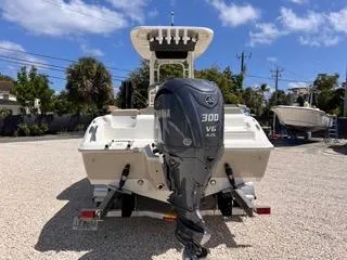 Slide: The Image of 2025 Key West 239 FS boat with Yamaha 300 V6 engine, parked on gravel. - 5