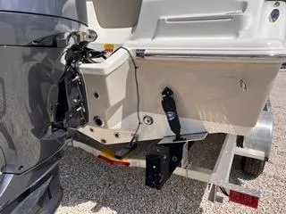 Slide: The Image of 2025 Key West 239 FS boat on trailer, rear view showing motor mount and hull details. - 7