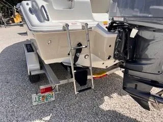 Slide: The Image of 2025 Key West 239 FS boat with ladder and outboard motor on trailer. - 8