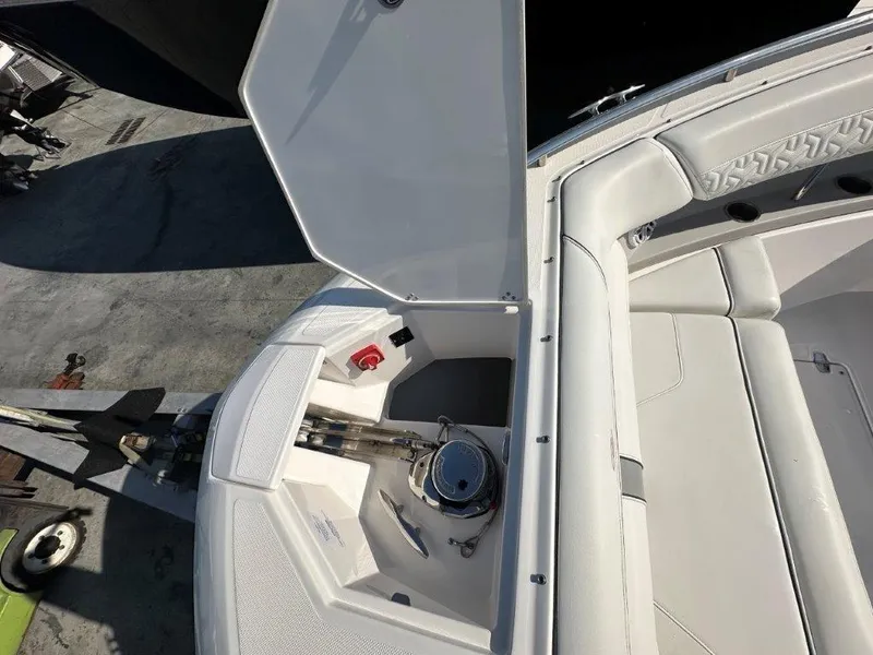 Slide: The Image of 2023 Regal LX36 boat anchor compartment with open hatch, showcasing sleek design and storage space. - 12