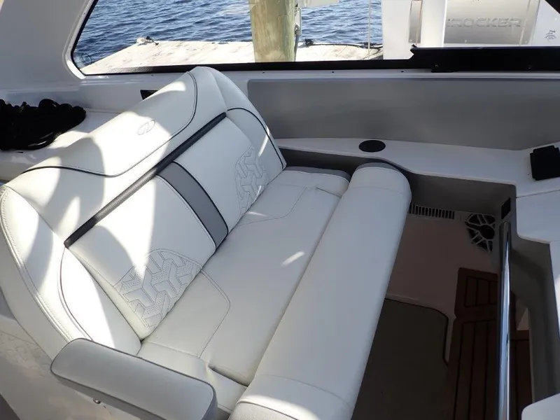 Slide: The Image of 2023 Regal LX36 boat interior with white leather seating and wood accents. - 26