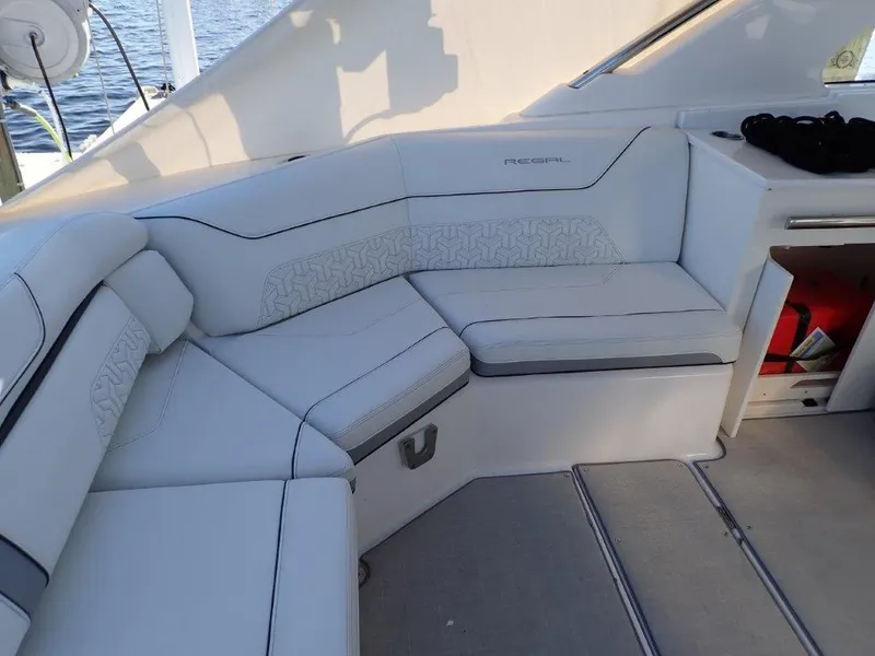 Slide: The Image of Luxurious seating area on 2023 Regal LX36 boat, featuring elegant white upholstery. - 29