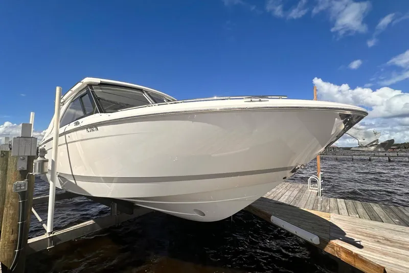 Slide: The Image of 2023 Regal LX36 boat docked under clear blue sky. - 3