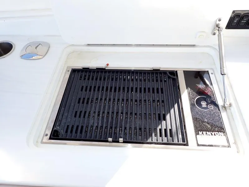 Slide: The Image of 2023 Regal LX36 boat grill with Kenyon cooktop, sleek design. - 41