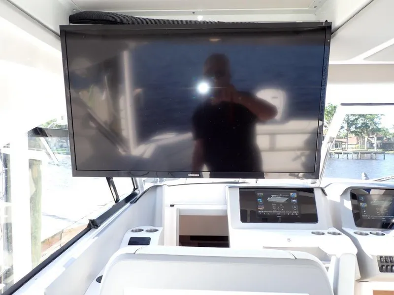 Slide: The Image of 2023 Regal LX36 boat helm with large screen display and modern controls. - 43
