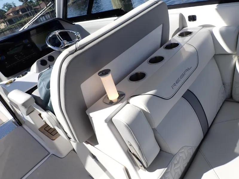 Slide: The Image of 2023 Regal LX36 boat interior with luxurious seating and cup holders. - 44