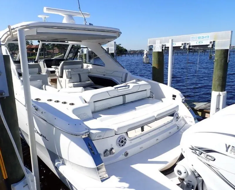 Slide: The Image of 2023 Regal LX36 luxury yacht docked by the water, showcasing sleek design and spacious seating. - 45