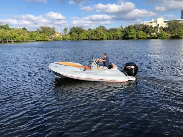 Slide: The Image of 2025 Zar Formenti 49 SL boat cruising on a calm lake under a partly cloudy sky. - 2