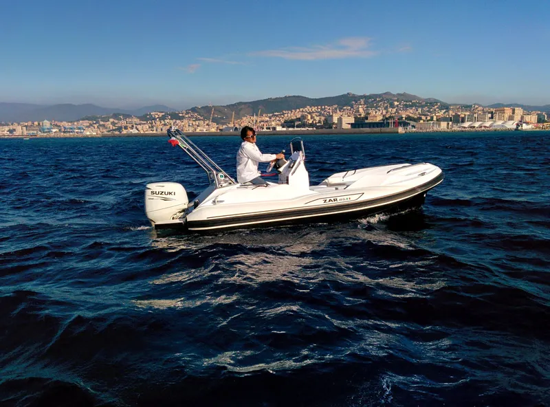 Slide: The Image of 2025 Zar Formenti 49 SL boat cruising on open water with cityscape in background. - 20