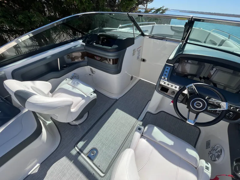 Slide: The Image of 2019 Chaparral 277 SSX boat interior with modern dashboard and seating. - 18