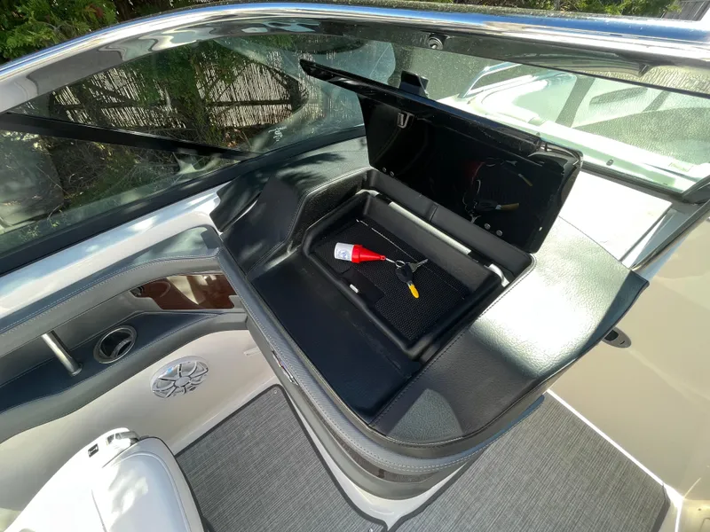 Slide: The Image of 2019 Chaparral 277 SSX boat interior with open storage compartment and accessories. - 19