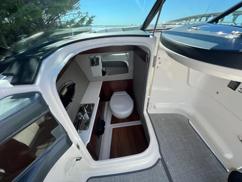 Slide: The Image of 2019 Chaparral 277 SSX boat interior with compact bathroom and toilet. - 20