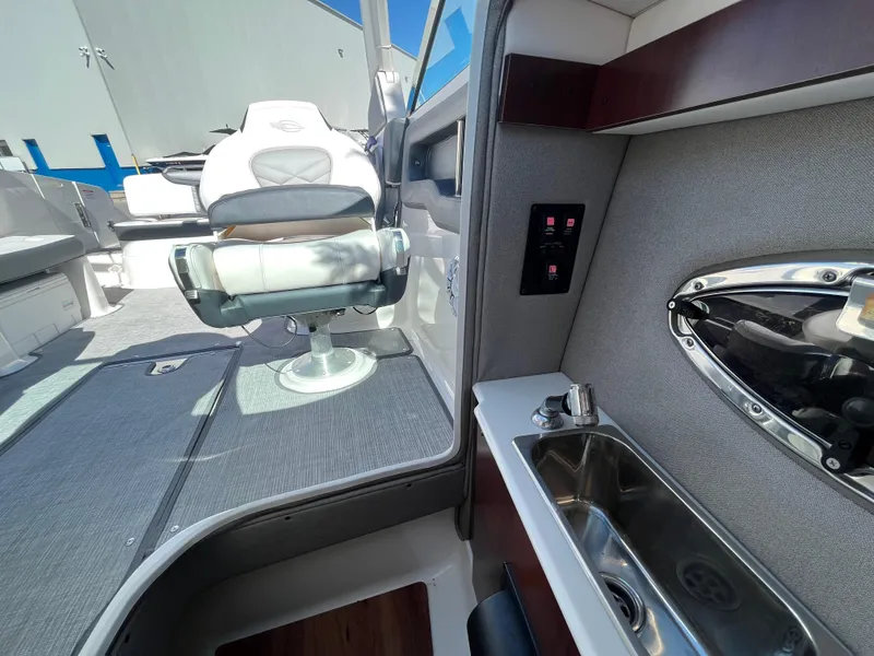 Slide: The Image of 2019 Chaparral 277 SSX interior with seating and sink, showcasing luxury boat features. - 22