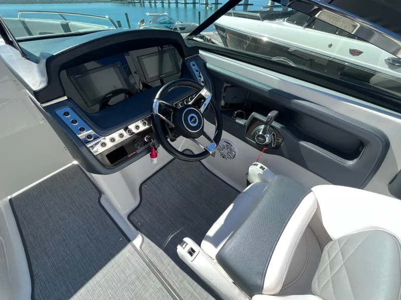 Slide: The Image of 2019 Chaparral 277 SSX boat cockpit with modern steering and control panel. - 25