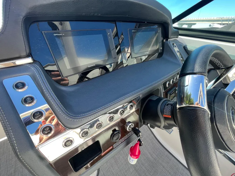 Slide: The Image of 2019 Chaparral 277 SSX dashboard with dual screens and steering wheel. - 26