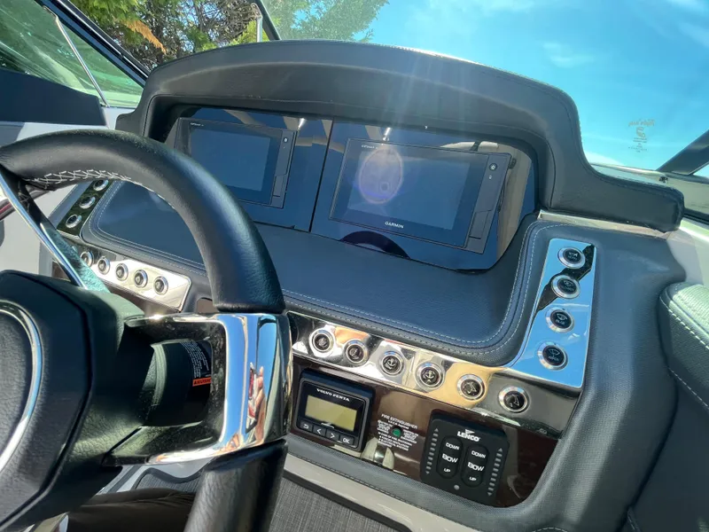 Slide: The Image of 2019 Chaparral 277 SSX dashboard with dual screens and control panel in sunlight. - 27