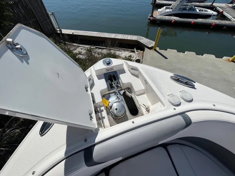 Slide: The Image of 2019 Chaparral 277 SSX boat with open anchor compartment at dockside. - 35