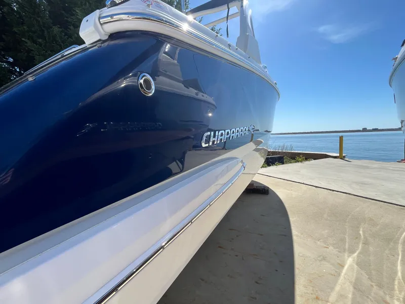 Slide: The Image of 2019 Chaparral 277 SSX boat docked by the water on a sunny day. - 4