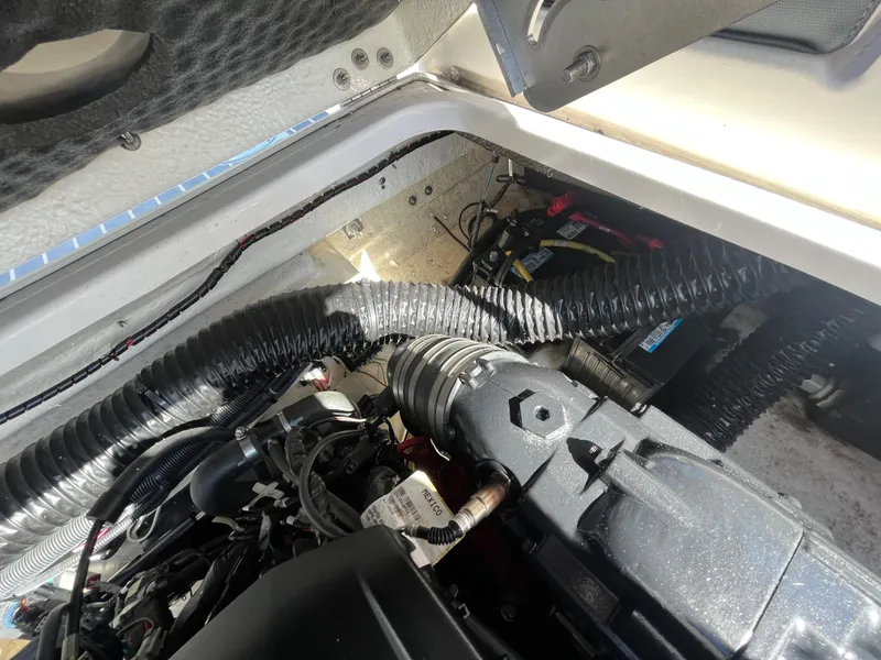 Slide: The Image of Engine compartment of a 2019 Chaparral 277 SSX boat, showing hoses and mechanical components. - 48