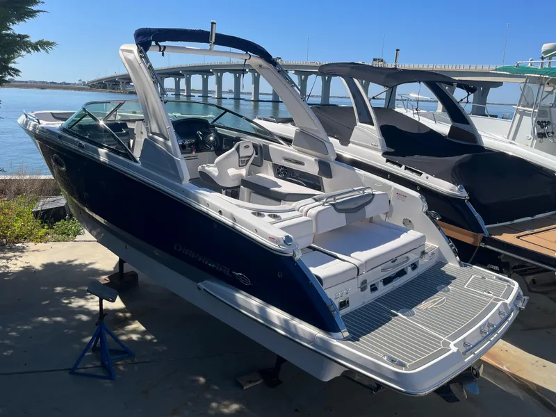 Slide: The Image of 2019 Chaparral 277 SSX boat docked near a bridge on a sunny day. - 7
