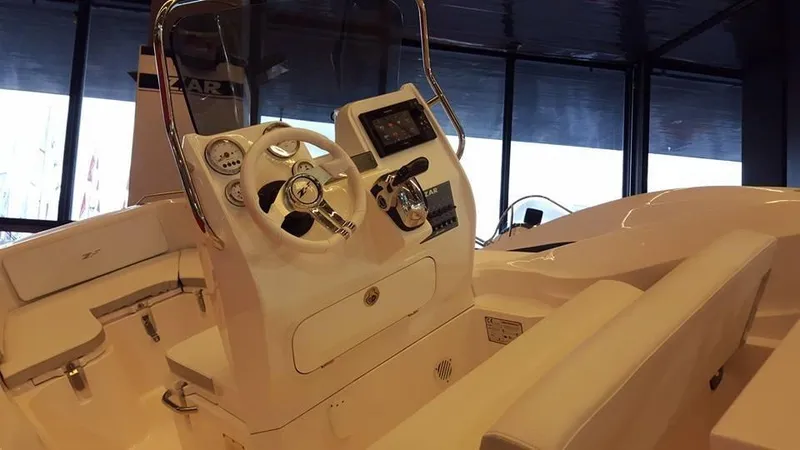 Slide: The Image of 2025 Zar Formenti 59 SL/Limited boat interior with modern dashboard and steering wheel. - 18