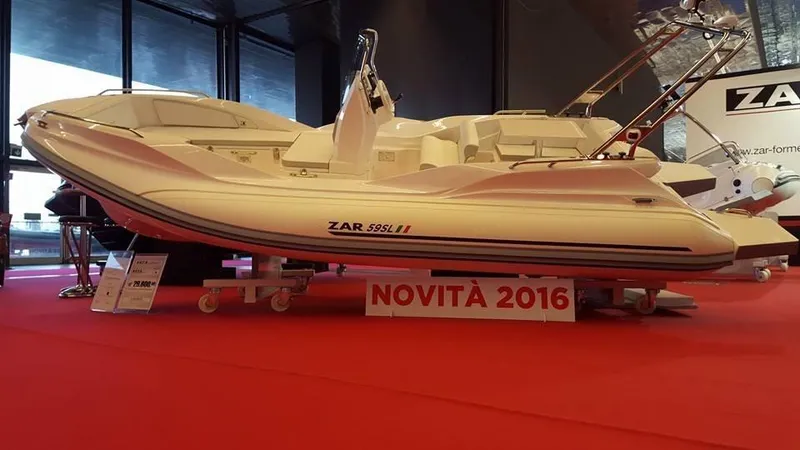 Slide: The Image of Zar Formenti 59 SL/Limited boat displayed indoors, red carpet, 2025 model. - 8