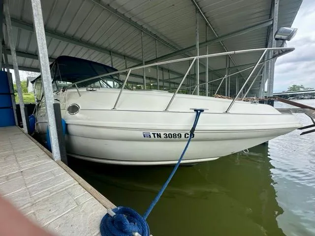 Slide: The Image of 1998 Rinker Fiesta Vee 266 boat docked in covered marina. - 3