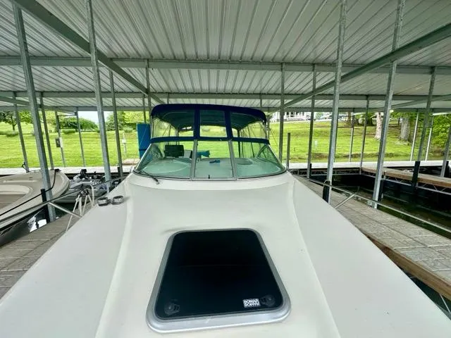 Slide: The Image of 1998 Rinker Fiesta Vee 266 boat docked under a covered marina. - 4