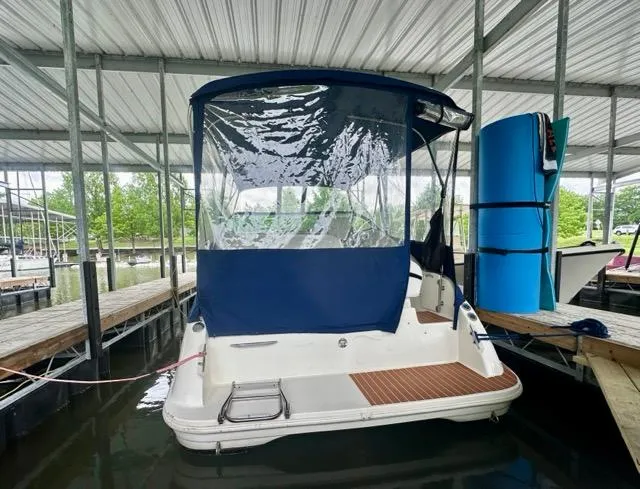 Slide: The Image of 1998 Rinker Fiesta Vee 266 boat docked under a covered marina. - 5