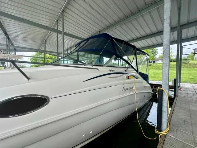 Slide: The Image of 1998 Rinker Fiesta Vee 266 boat docked under a covered marina. - 7