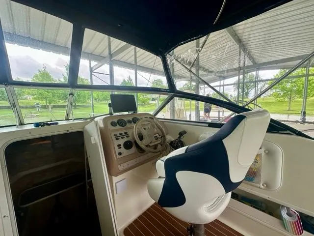 Slide: The Image of Interior view of 1998 Rinker Fiesta Vee 266 boat cockpit with steering wheel and controls. - 9