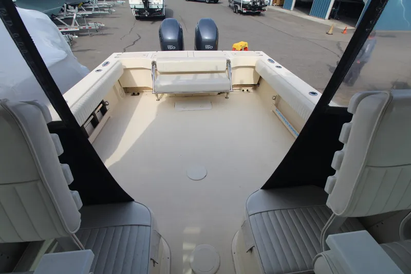 Slide: The Image of 2012 Parker 2510 XLD Walkaround boat interior with seating and twin engines. - 14