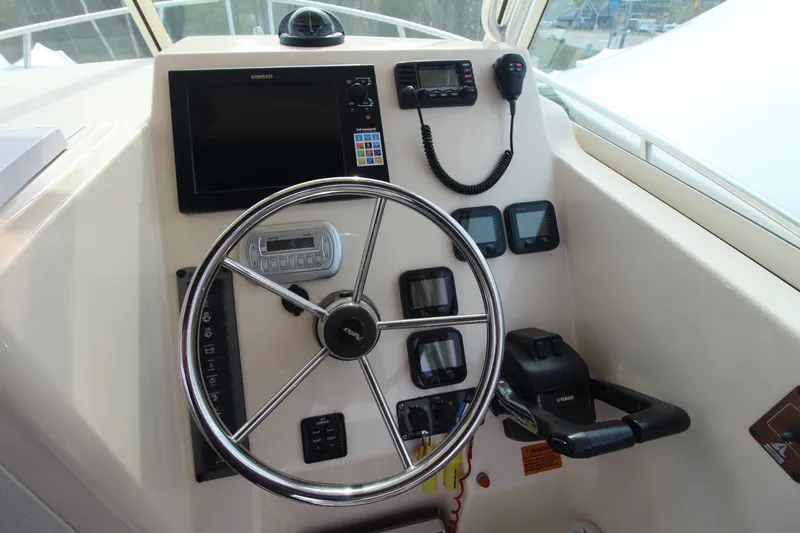 Slide: The Image of Control panel of 2012 Parker 2510 XLD Walkaround boat with steering wheel and navigation equipment. - 16