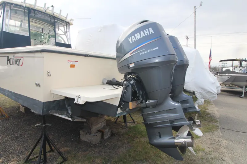 Slide: The Image of 2012 Parker 2510 XLD Walkaround with Yamaha outboard motor, displayed on stands. - 4