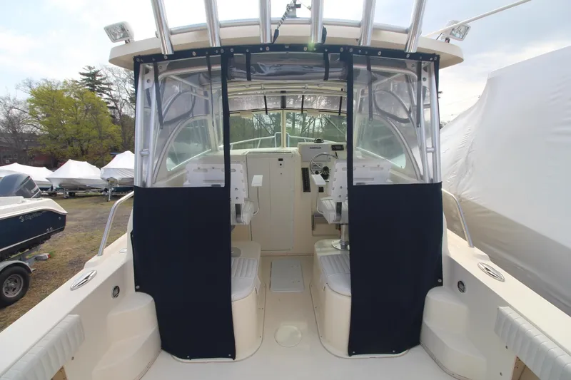 Slide: The Image of 2012 Parker 2510 XLD Walkaround boat interior with seating and helm. - 6