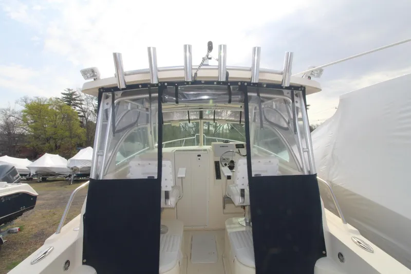 Slide: The Image of 2012 Parker 2510 XLD Walkaround boat, featuring dual seats and a spacious cockpit. - 7