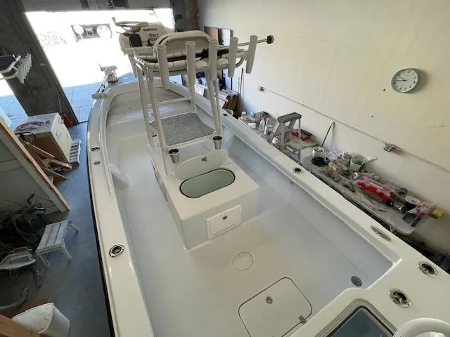 Slide: The Image of 1986 Aquasport Tournament 222 boat in a workshop, showcasing spacious deck and equipment. - 12
