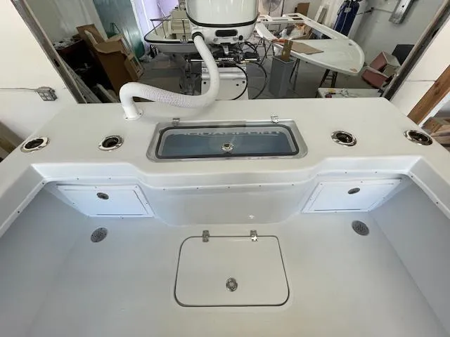 Slide: The Image of 1986 Aquasport Tournament 222 boat interior with storage compartments and fishing rod holders. - 14