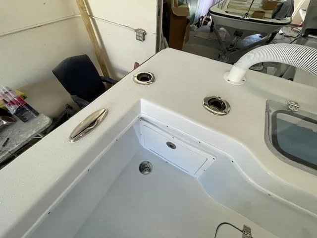 Slide: The Image of 1986 Aquasport Tournament 222 boat interior with rod holders and storage compartment. - 15