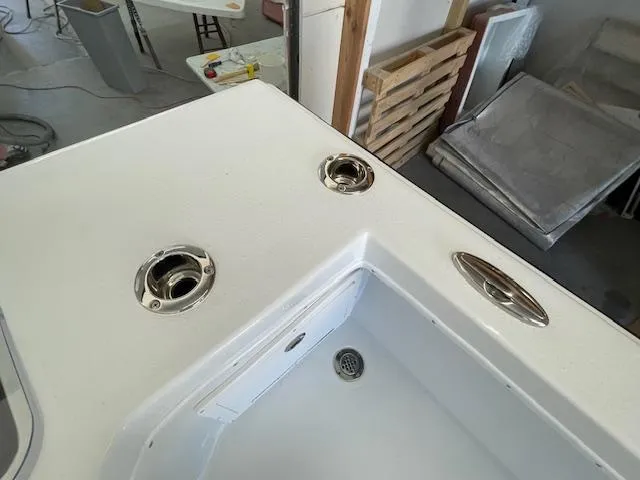 Slide: The Image of 1986 Aquasport Tournament 222 boat deck with rod holders and storage compartment. - 19