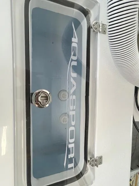 Slide: The Image of 1986 Aquasport Tournament 222 boat compartment with logo and latch. - 20