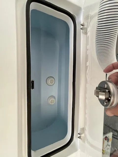 Slide: The Image of 1986 Aquasport Tournament 222 livewell with open lid and visible plumbing components. - 21