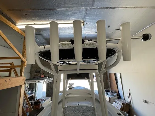 Slide: The Image of 1986 Aquasport Tournament 222 boat in garage, viewed from above, showcasing rod holders and equipment. - 22