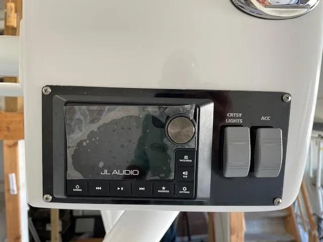 Slide: The Image of Control panel of a 1986 Aquasport Tournament 222 with JL Audio system and switches. - 24